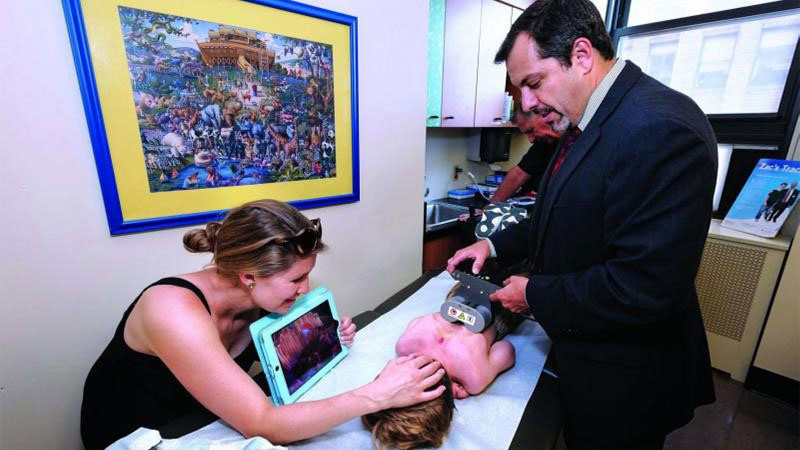 Dr. Michael Vitale adjusting child’s MAGEC rods to straighten spine