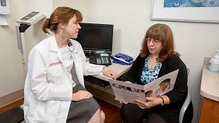 A radiation oncology specialist reviews treatment options with a patient