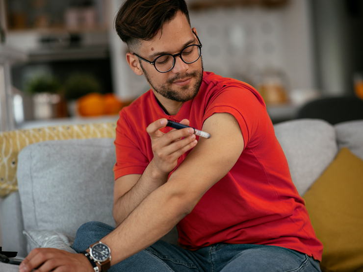 image of a man giving himself an insulin injection