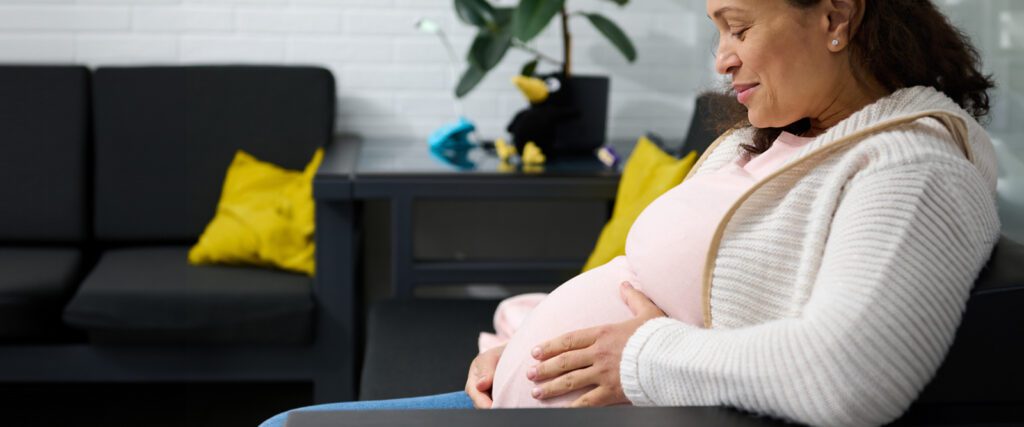woman looking and holding her belly