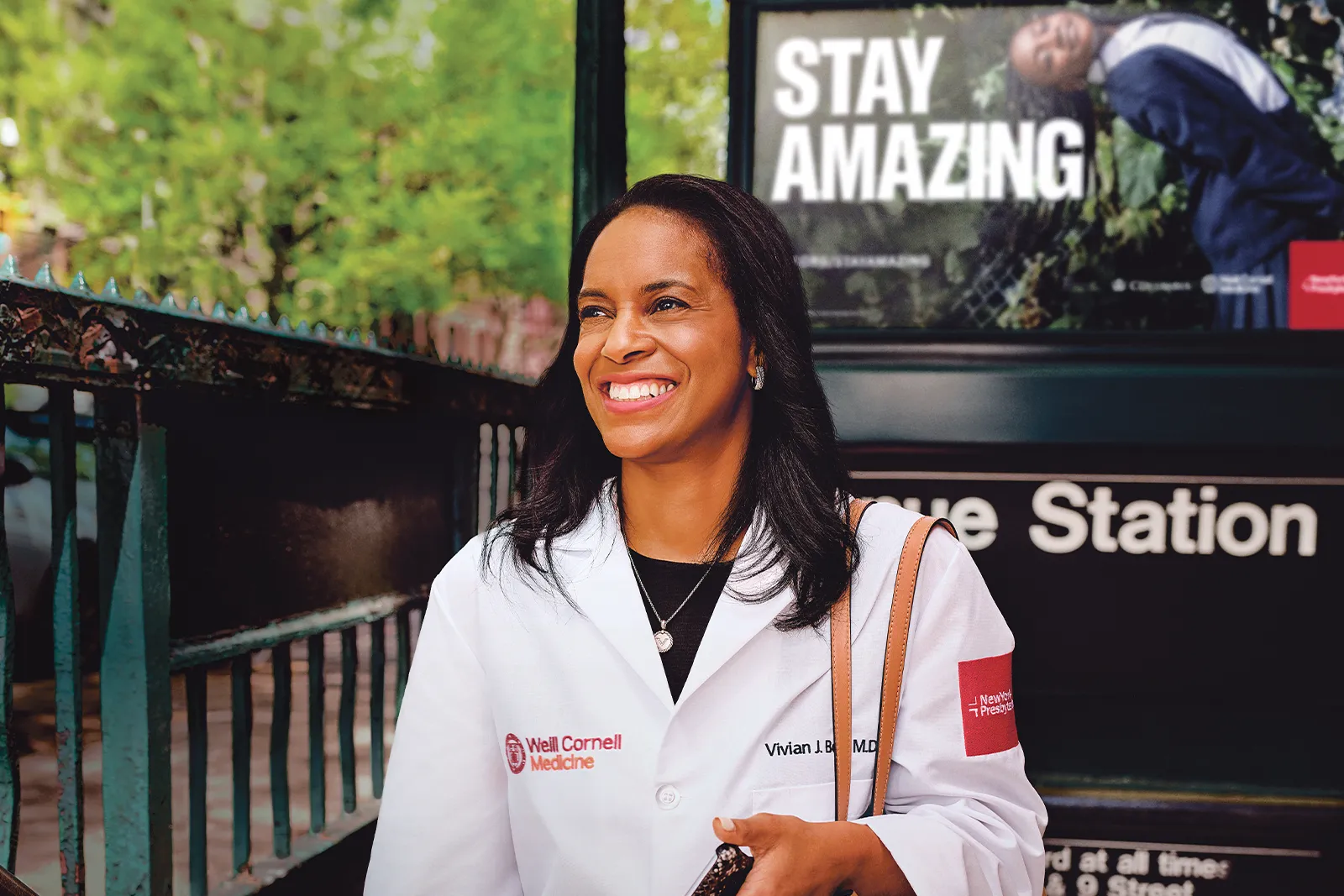 female doctor smiling while getting out of subway station