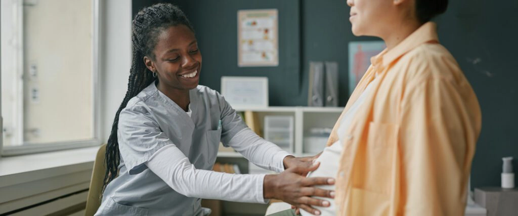 practioner checking a pregnant woman's belly